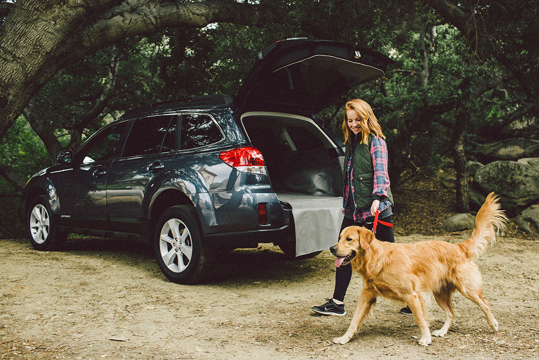 Woman With Dog In Subaru Outback with Cargo Liner